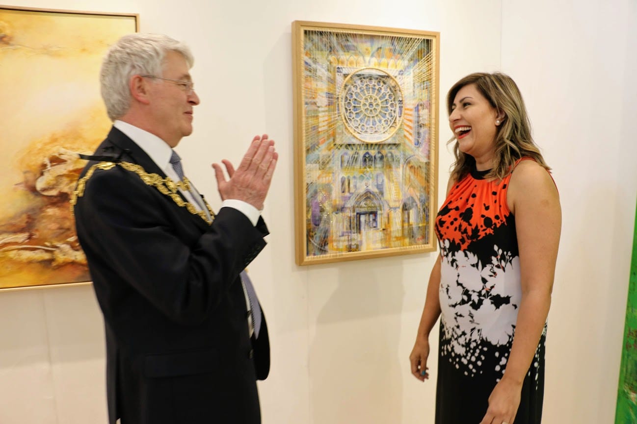 The Mayor of Kensington and Chelsea in conversation with an artist beside her work.