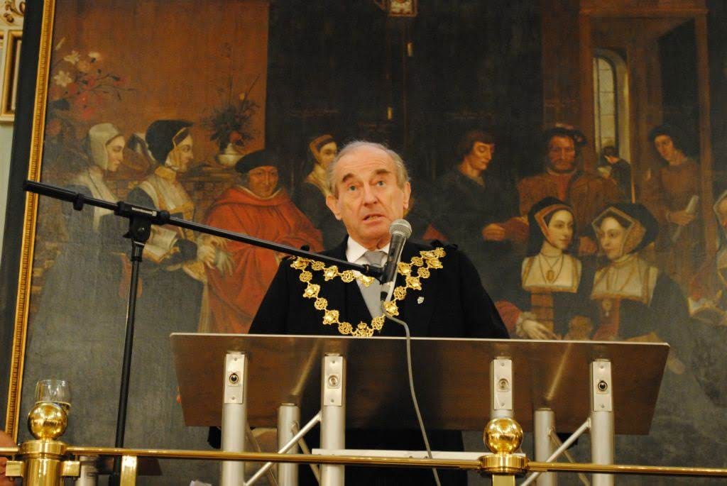 The Mayor of Kensington and Chelsea speaking from the lectern beneath the hall’s murals.