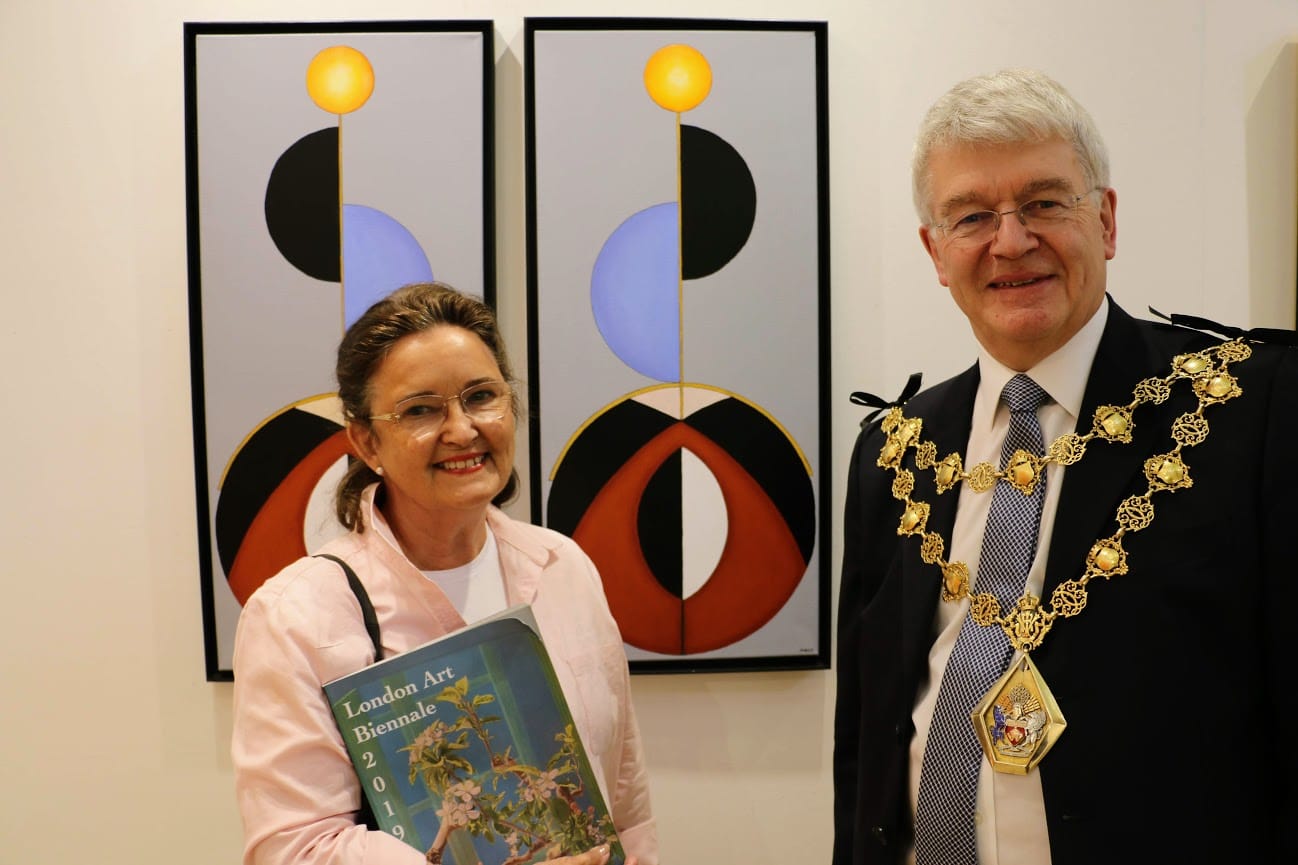 The Mayor of Kensington and Chelsea with an artist holding the Biennale catalogue.
